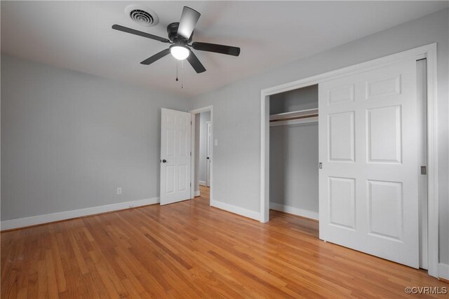 unfurnished bedroom featuring ceiling fan, light hardwood / wood-style floors, and a closet