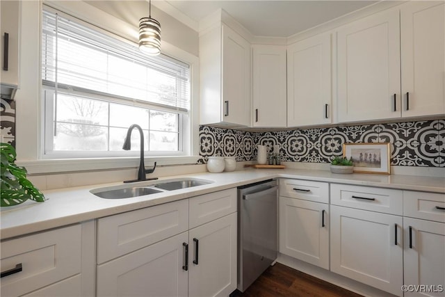 kitchen featuring white cabinetry, sink, stainless steel dishwasher, and backsplash
