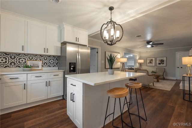 kitchen with white cabinetry, dark wood-type flooring, and decorative light fixtures