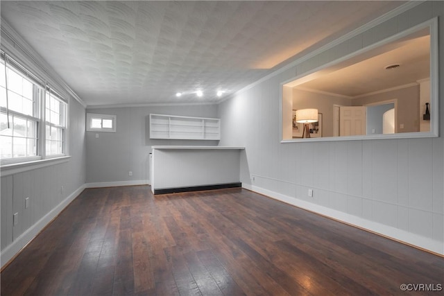 unfurnished living room featuring ornamental molding and dark wood-type flooring