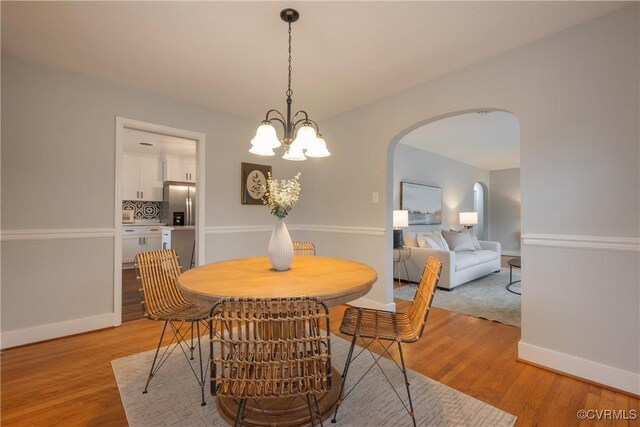 dining room with an inviting chandelier and light hardwood / wood-style floors