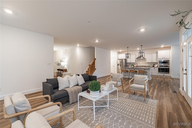 living room featuring hardwood / wood-style floors and sink