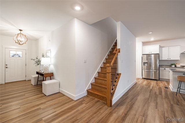 entrance foyer with a chandelier and light hardwood / wood-style flooring