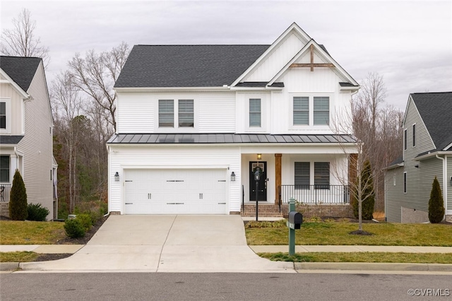 view of front of home with a garage, a porch, and a front yard