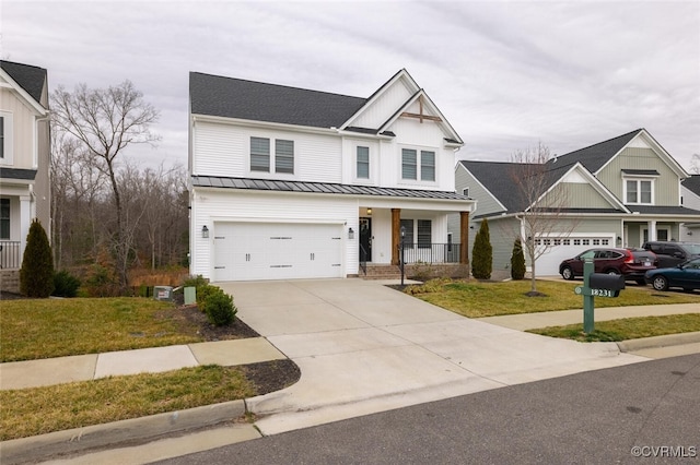 view of front of property with a garage, covered porch, and a front lawn