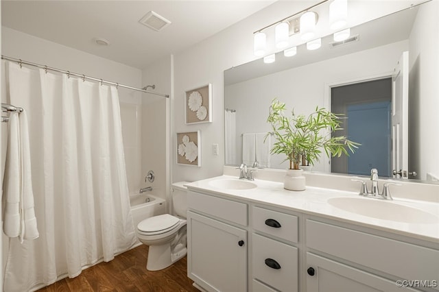 full bathroom with vanity, hardwood / wood-style floors, shower / bath combination with curtain, and toilet