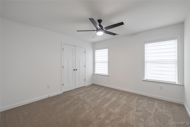 empty room with light colored carpet and ceiling fan