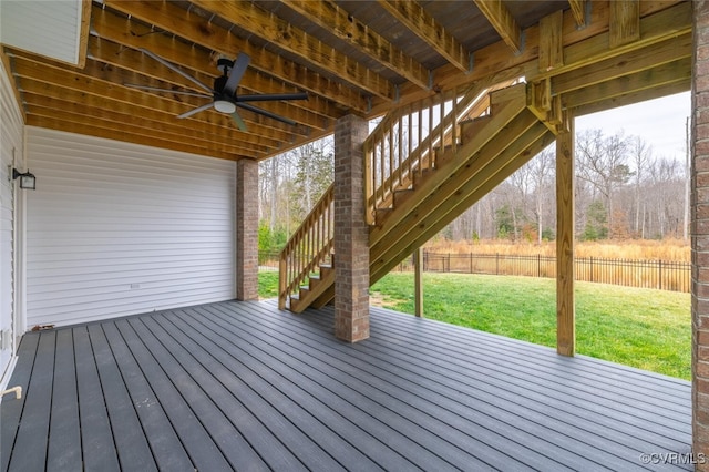 wooden terrace with a lawn and ceiling fan