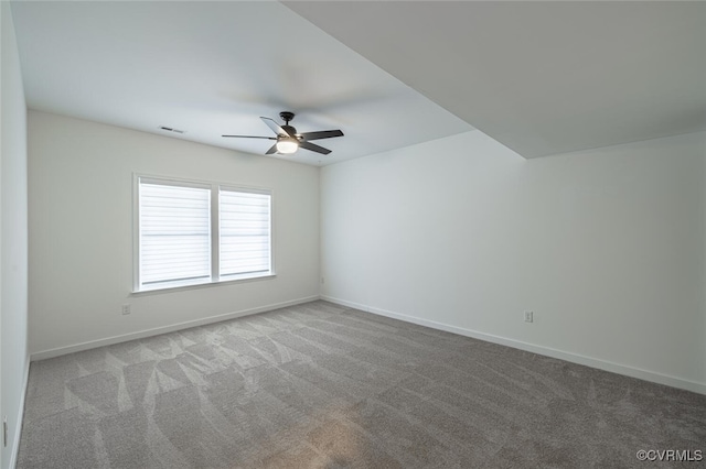 carpeted spare room with ceiling fan