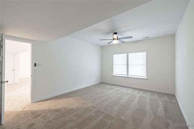 carpeted spare room with ceiling fan