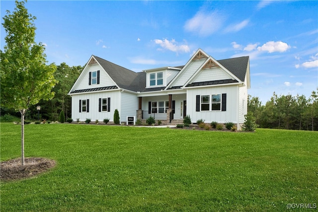 view of front of house with a front yard and a porch