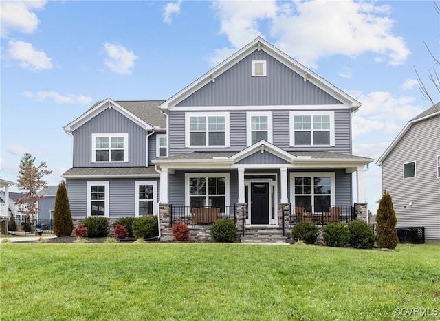 craftsman house featuring a front lawn and covered porch