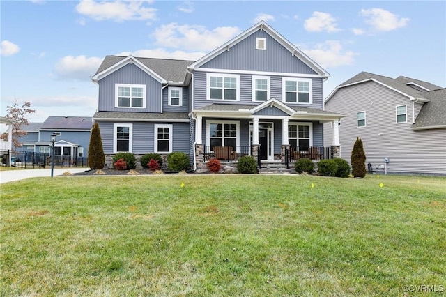 craftsman house with a front lawn and a porch