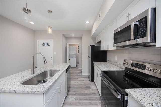2414 Marion Mashore St, Richmond, VA 23224 - kitchen featuring sink, white cabinetry, decorative light fixtures, appliances with stainless steel finishes, and an island with sink