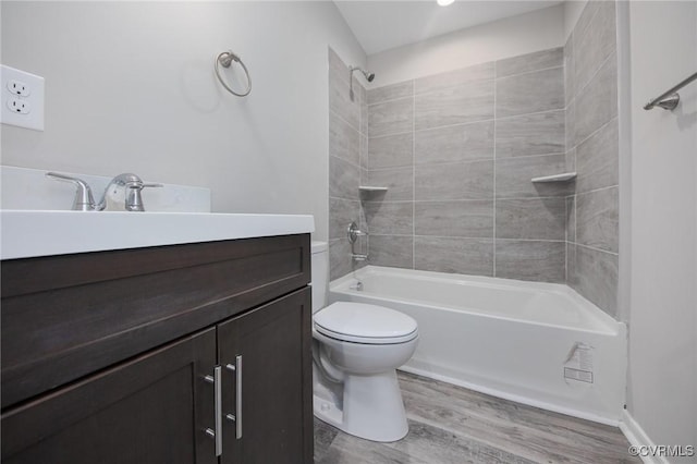 2414 Marion Mashore St, Richmond, VA 23224 - full bathroom featuring vanity, toilet, tiled shower / bath combo, and hardwood / wood-style floors