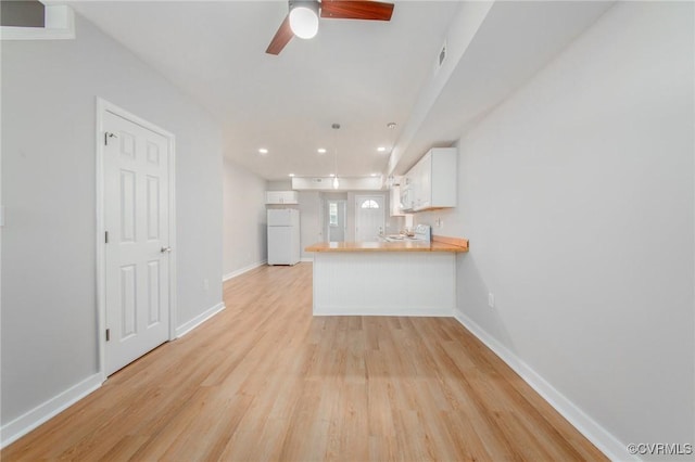 2414 Marion Mashore St, Richmond, VA 23224 - kitchen with light hardwood / wood-style flooring, ceiling fan, white cabinets, kitchen peninsula, and white fridge