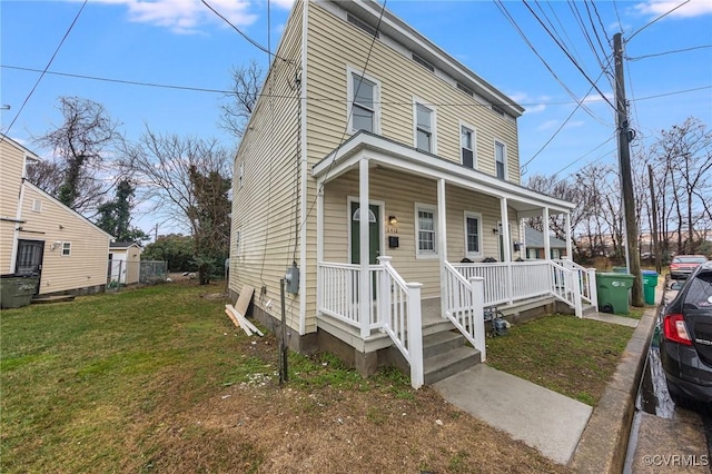 view of front of home with a front yard and covered porch