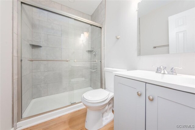 2414 Marion Mashore St, Richmond, VA 23224 - bathroom featuring walk in shower, vanity, toilet, and hardwood / wood-style flooring