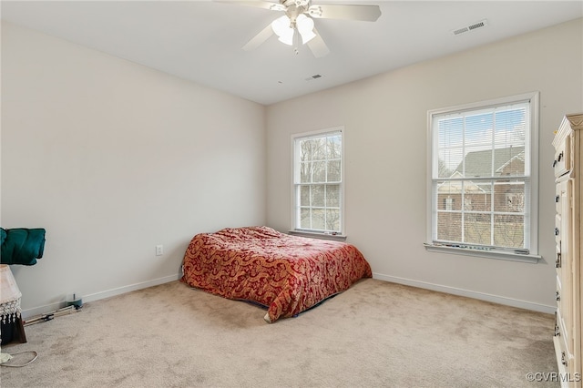 bedroom with ceiling fan and light carpet