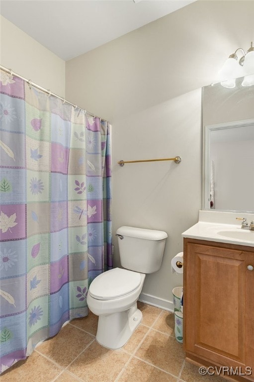 bathroom featuring vanity, tile patterned floors, and toilet