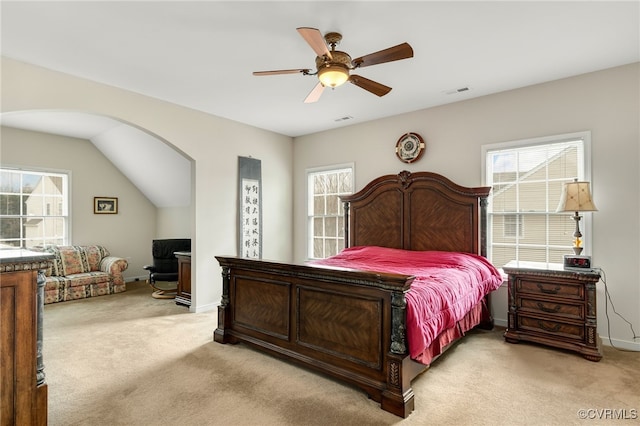 bedroom with multiple windows, light colored carpet, and ceiling fan