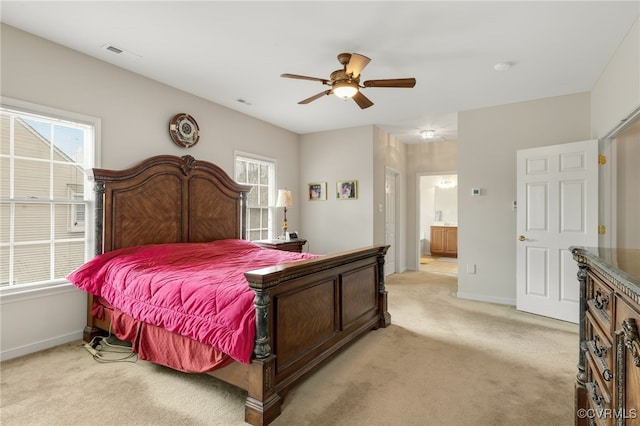 carpeted bedroom with ceiling fan and connected bathroom