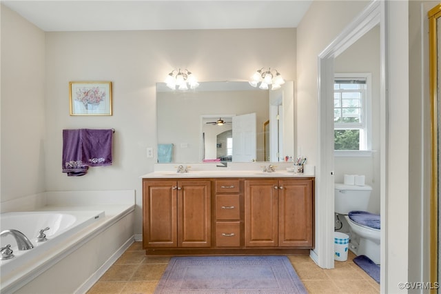 bathroom with tile patterned flooring, vanity, a bathtub, and toilet