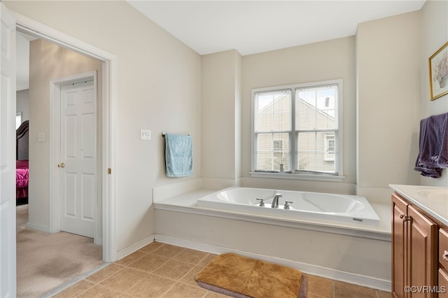 bathroom with a tub to relax in and vanity