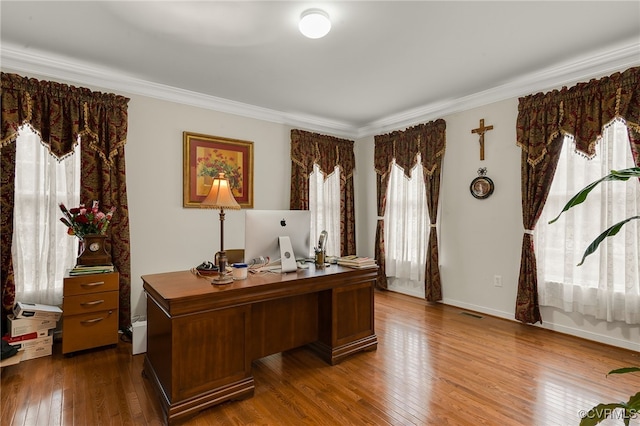 home office featuring hardwood / wood-style flooring and crown molding