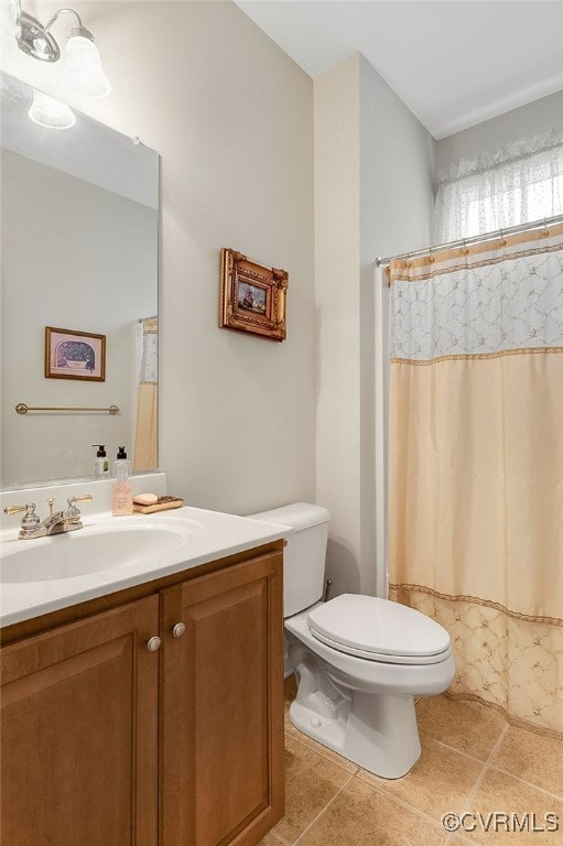 bathroom with tile patterned floors, toilet, and vanity