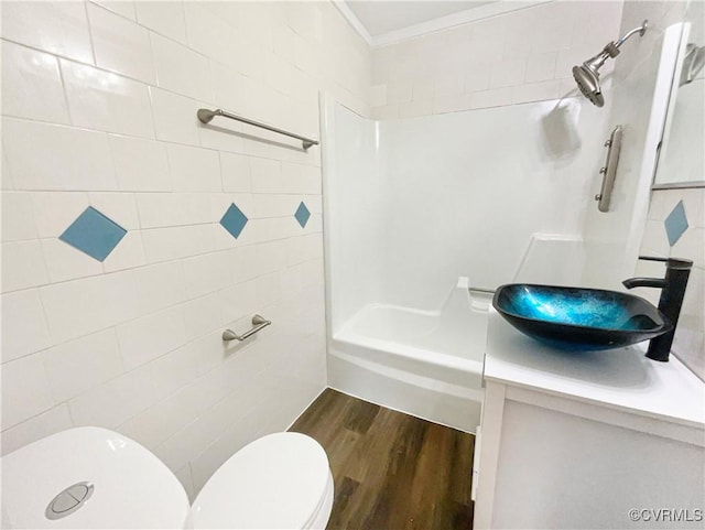 bathroom featuring wood-type flooring, tile walls, vanity, and toilet