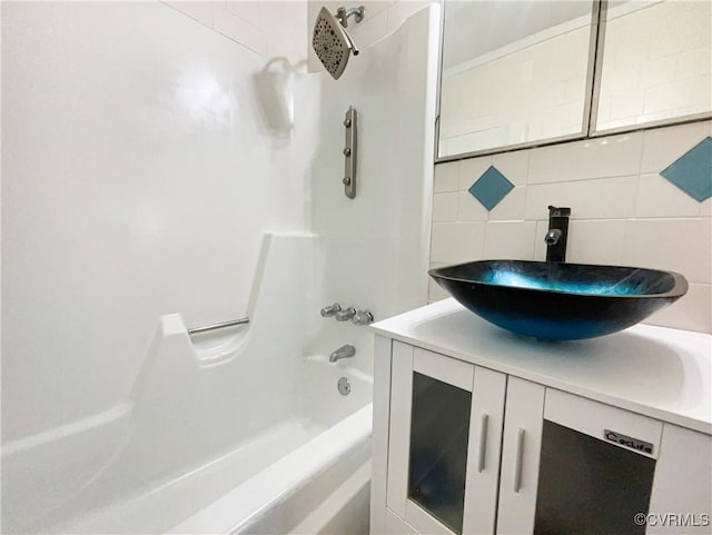 bathroom featuring tasteful backsplash, shower / tub combination, and vanity