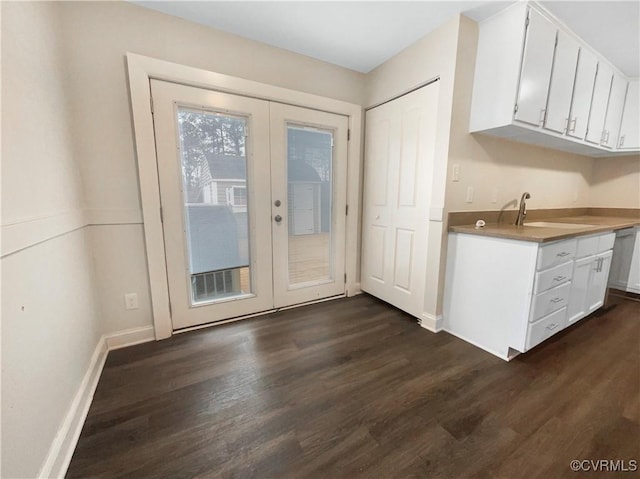 kitchen featuring sink, dark wood-type flooring, french doors, and white cabinets