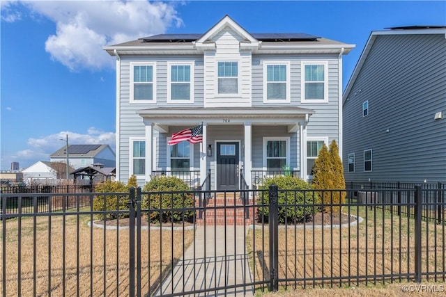 view of front facade featuring a front yard, solar panels, and covered porch