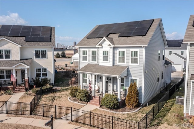 view of property featuring central AC unit and solar panels