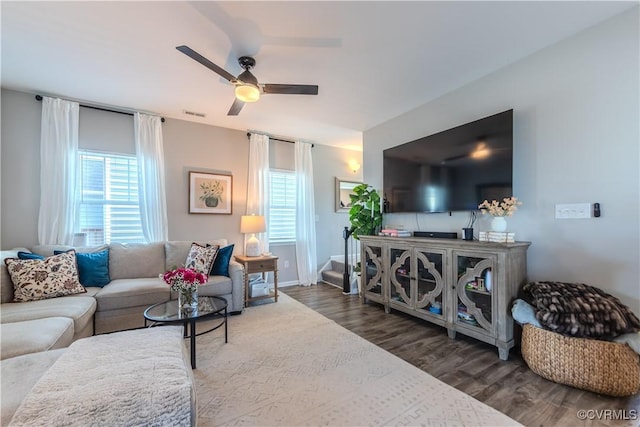 living room with ceiling fan, plenty of natural light, and dark hardwood / wood-style flooring