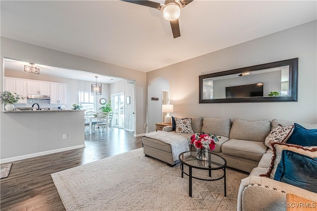 living room with sink, hardwood / wood-style floors, and ceiling fan