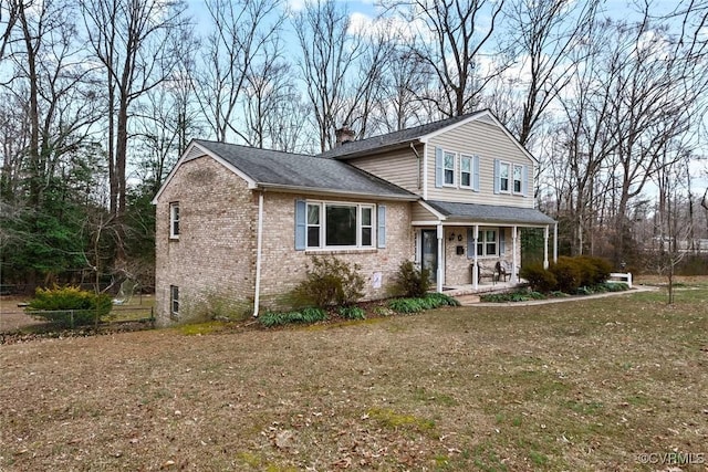 view of front of property with a porch and a front lawn