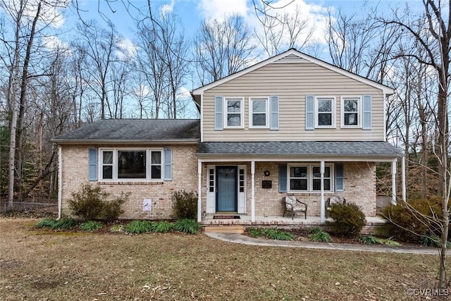 view of front of home featuring covered porch and a front lawn