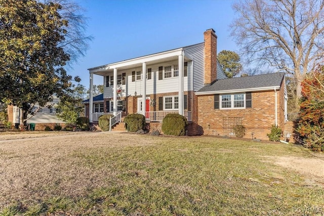 view of front of home featuring a front yard and a porch