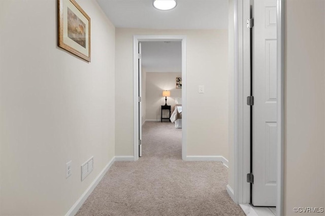 hallway with light colored carpet