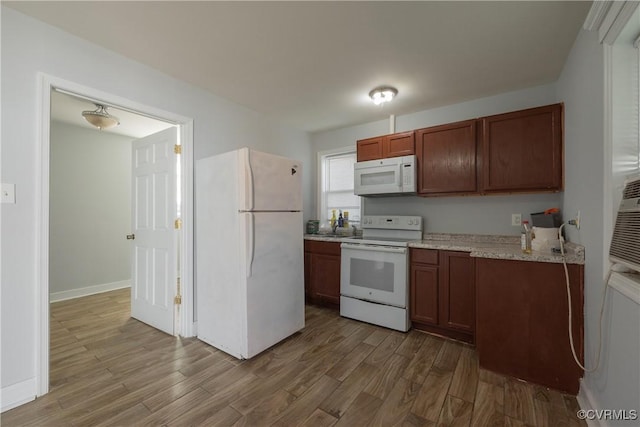 kitchen with white appliances and hardwood / wood-style flooring