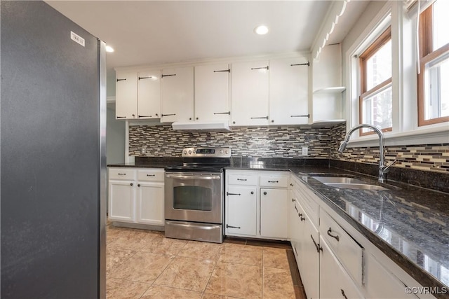 kitchen featuring sink, decorative backsplash, stainless steel appliances, and white cabinets