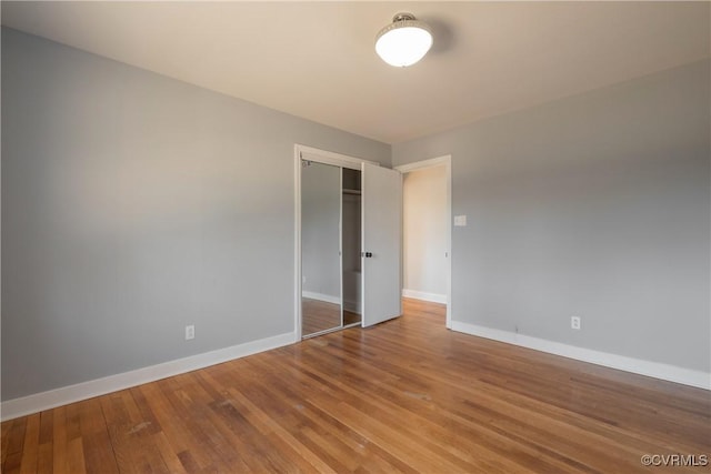 unfurnished room with wood-type flooring