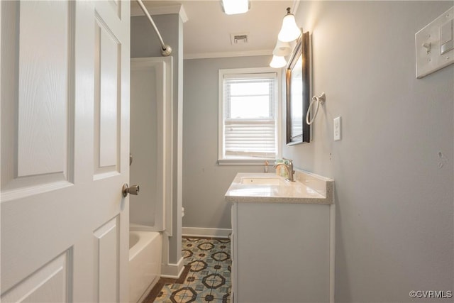 bathroom with vanity, crown molding, and tub / shower combination