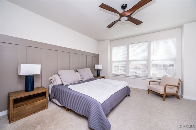 bedroom featuring light carpet and ceiling fan