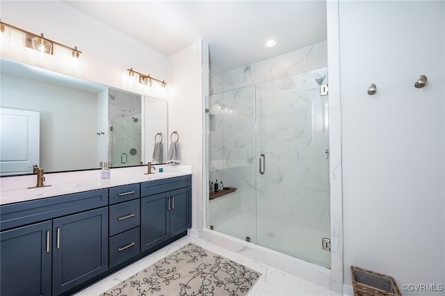 bathroom featuring a shower with door and vanity