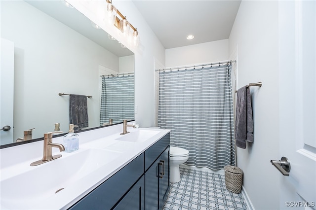 bathroom featuring vanity, toilet, and a shower with shower curtain