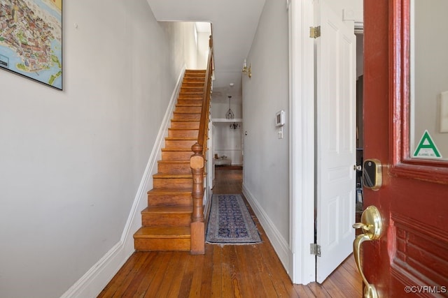 stairway with hardwood / wood-style flooring