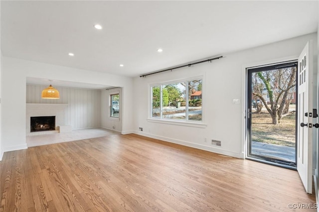 unfurnished living room with light wood-type flooring